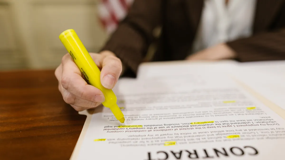 person highlighting a contract document