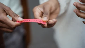 hands passing a coupon ticket